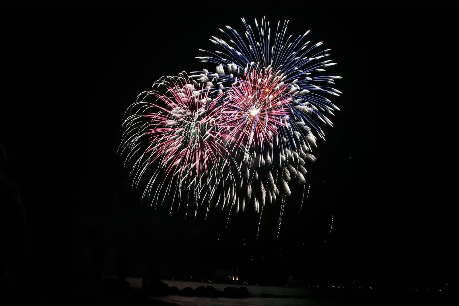 Vibrant fireworks lighting up the night sky with colorful bursts.