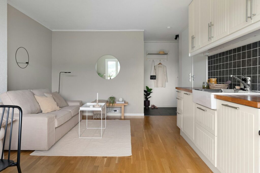 A living room filled with furniture and a wooden floor
